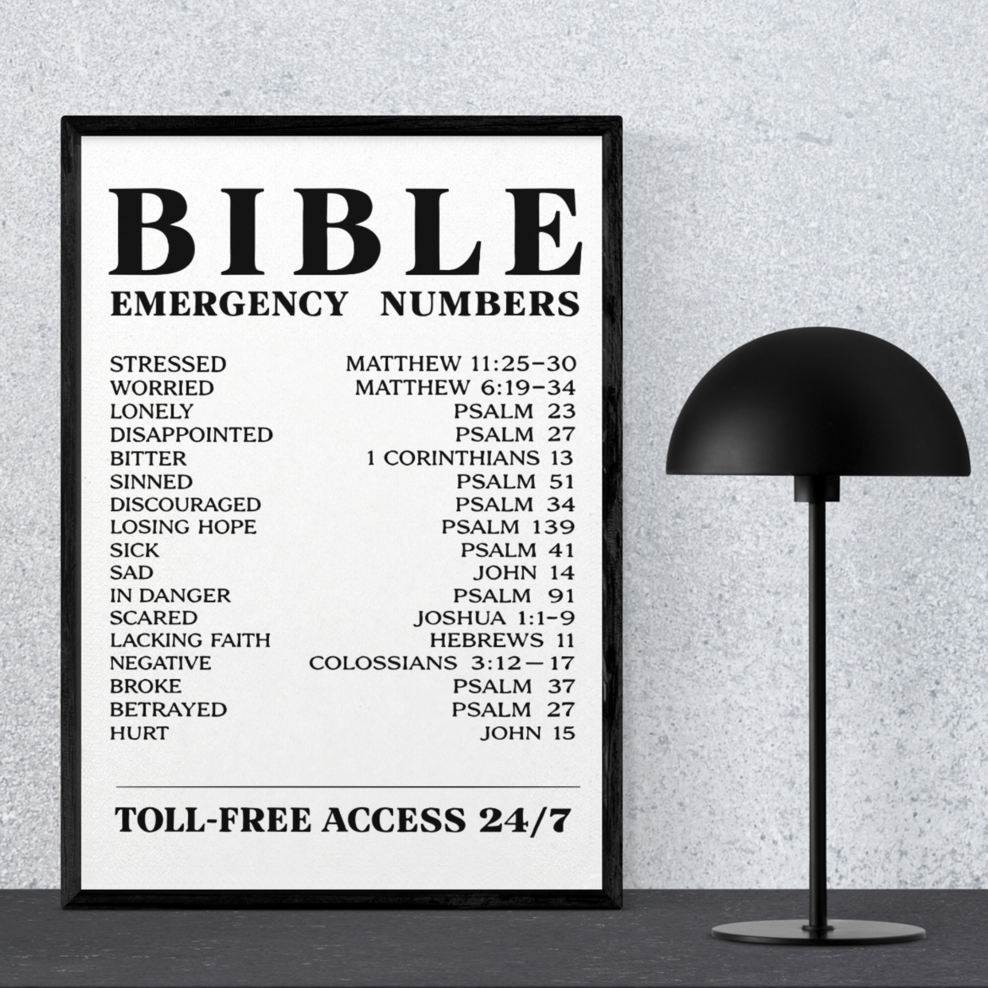 Bible Emergency Numbers poster in a sleek black frame sitting on a desk next to a modern black lamp
